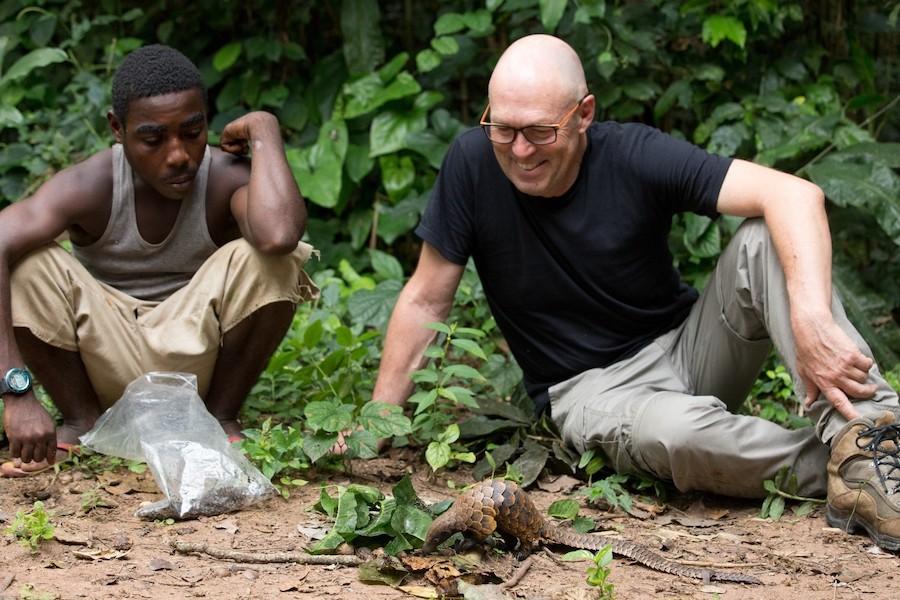 Filmmaker Bruce Young and a member of the Baíaka tribe with a Black-Bellied Pangolin in Central African Republic Image