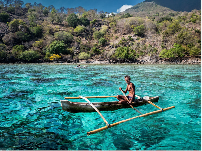 Fisher people such as this fisherman in Indonesia are struggling to make a living from the sea as coral reefs bleach and fish stocks decline. Erik Lukas, Ocean Image Bank. Image