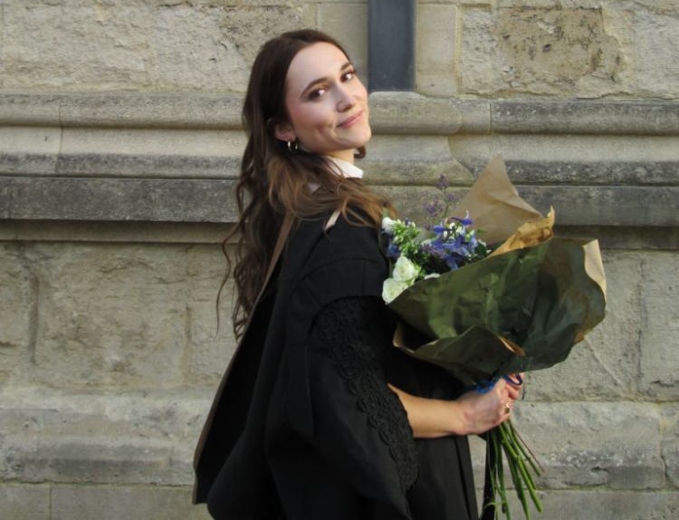 an image of Bethany “Bee” Smith holding flowers.